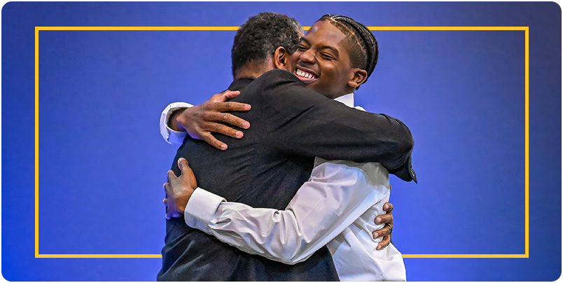 Embrace between Impact Awards Honoree and Nominator