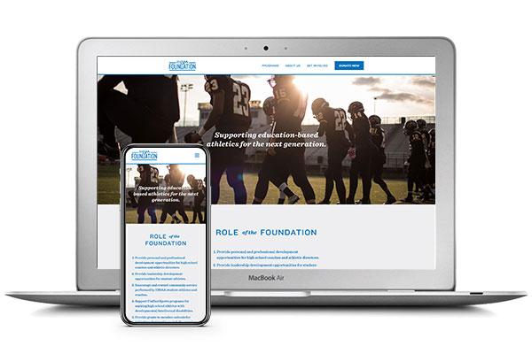 A laptop and cell phone display examples of the IHSAA Foundation website.