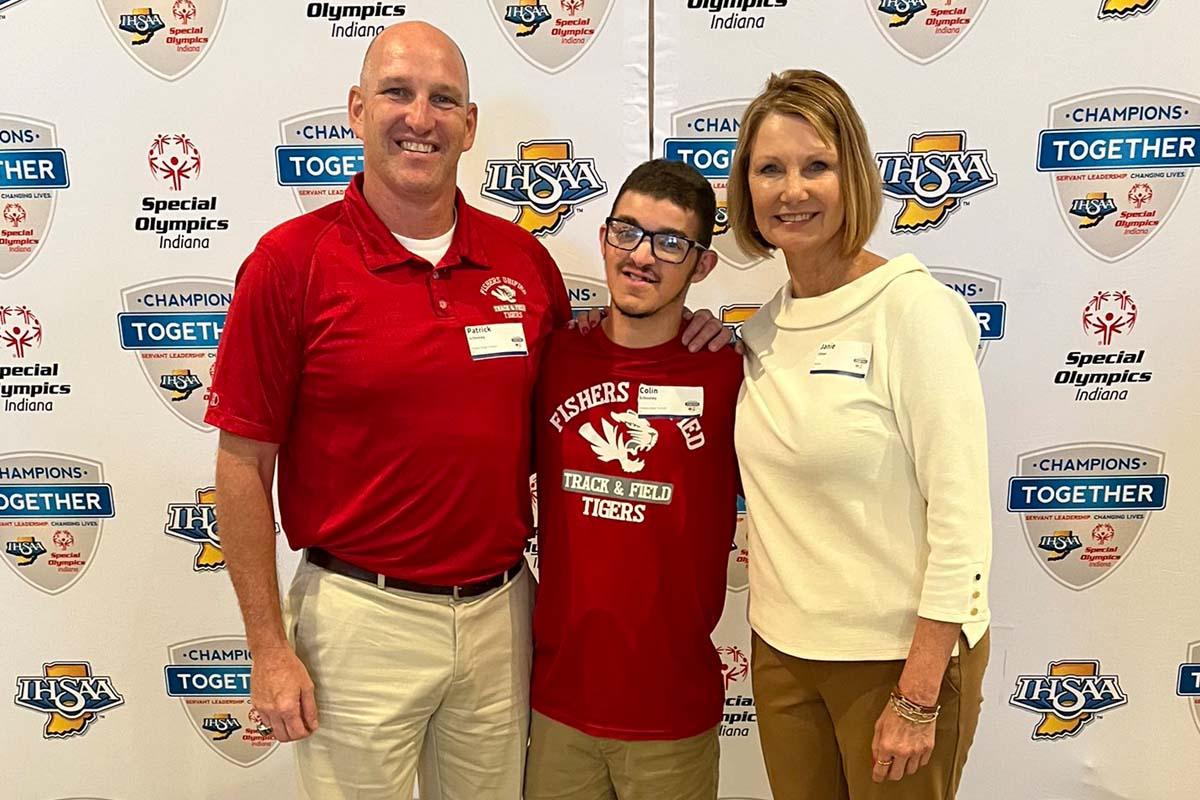 Image of the new Assistant Commissioner of the IHSAA, Janie Ulmer, with Fishers Unified Track and Field student-athlete and coach.