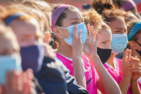 Student-athletes wear masks on the sidelines of the 2020 IHSAA girls soccer state finals.